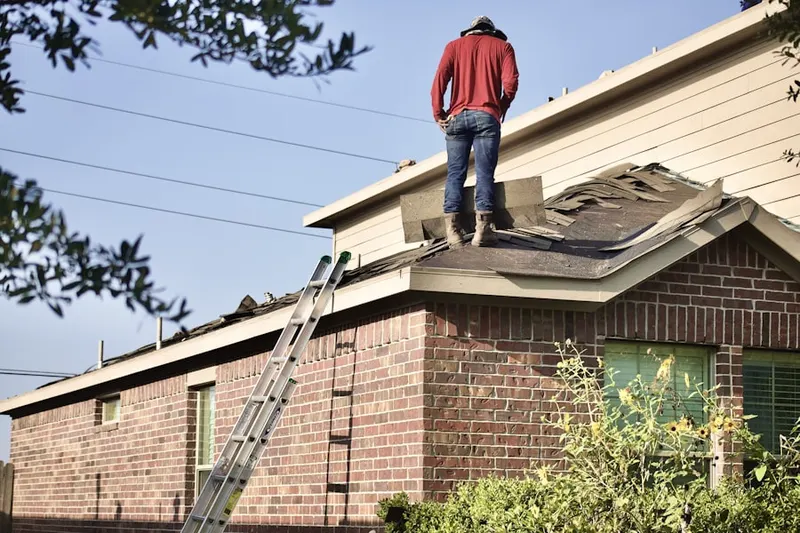 Professional roofer working on a residential roof in Dayton Meadows